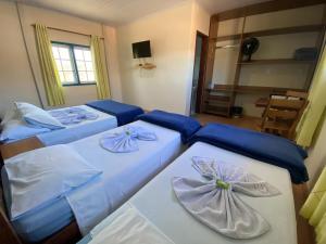 En eller flere senge i et værelse på Pousada Turismo