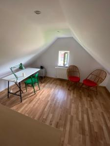 a room with a table and two chairs in a attic at Siedlisko Glinnik in Glinnik