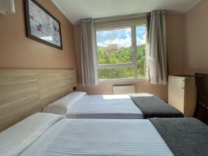 Säng eller sängar i ett rum på Somriu Hotel Vall Ski