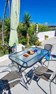 a table and chairs with a plate of food on it at Chrysanthi Melitsa apts. in Sidari
