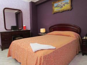 Ένα ή περισσότερα κρεβάτια σε δωμάτιο στο Hotel Lisboa