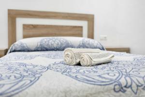 Łóżko lub łóżka w pokoju w obiekcie Apartamento Venus 1