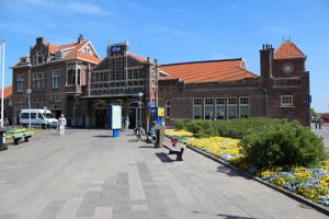 a building with benches in front of a building at Hotel Arosa in Zandvoort