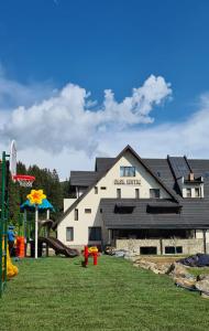 a building with a playground in front of it at Casa Iustin in Moroeni