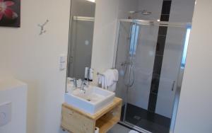 a bathroom with a sink and a shower at Logis Hotel De La Poste in Saint-Sauves- dʼAuvergne