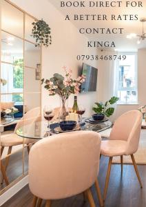 a dining room with a table and chairs with a glass table at Best Price - Contact us -Cityscape Beautiful Apartment in the Heart of the Action in Southampton