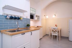 a small kitchen with a sink and a table at Blue Ribbon Apartment in Budapest