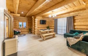 a living room in a log cabin with a couch and a table at BRZOZOWY SZELEST in Ustrzyki Dolne