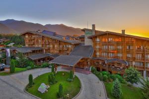 an aerial view of a hotel with mountains in the background at Pirin Golf Hotel Private Studios - Sani, Bansko in Razlog