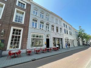 people sitting outside of a building at Bossche Suites No2 - Verwersstraat in Den Bosch