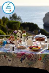 カルヴォエイロにあるOs Reais - Apt in front of the beach in Centeanesのテーブル(上に食べ物と飲み物付)