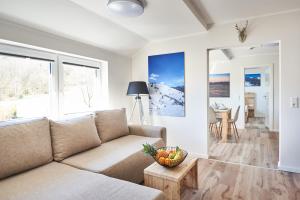 a living room with a couch and a table at Smart Resorts Haus Saphir Ferienwohnung 507 in Winterberg