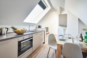 a kitchen with a sink and a table with chairs at Smart Resorts Haus Saphir Ferienwohnung 511 in Winterberg