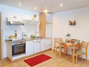 a kitchen with a table and a dining room at Ferienwohnung Sonnenblick in Edersee
