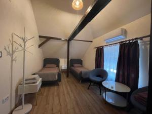A bed or beds in a room at Battonya House
