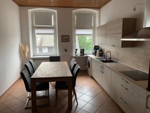 a kitchen with a table and chairs in a kitchen at Ferienwohnung Branka in Essen