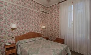 Postel nebo postele na pokoji v ubytování Hotel Villa Flores