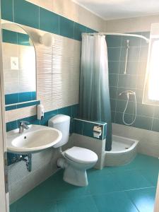 a bathroom with a toilet and a sink and a shower at Apartments MiaMaja in Novalja