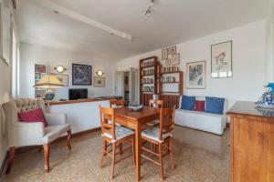a living room with a table and chairs and a couch at Roomy and Bright Apartment with Terrace in Rome