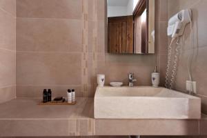 a bathroom with a white sink and a mirror at Kamares Villas in Kamáres +66 photos