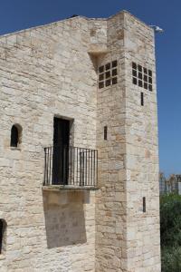 a building with a balcony on the side of it at Hotel Torre Domini in Giovinazzo