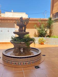 a fountain in the middle of a courtyard at White studio in Torrevieja