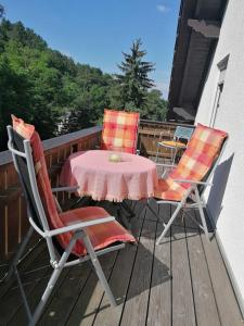 a table and two chairs on a deck with a table and chairs at Ferienwohnung Schaefer in Heppenheim an der Bergstrasse