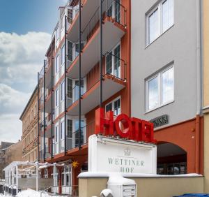 a building with a sign for a hotel at Hotel Wettiner Hof in Riesa