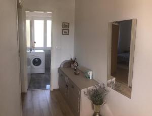 a bathroom with a sink and a washing machine at Elena in Benkovac