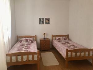 a bedroom with two beds and a dresser in it at Elena in Benkovac
