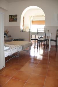 a living room with a table and chairs and a floor at Holiday Beach in Milazzo