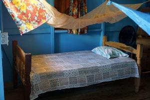 a bedroom with a bed with a mosquito net at Cool Spot Grace Place in Little Corn Island