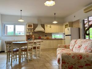 a kitchen and dining room with a table and a refrigerator at Villa Marta- Puglia Mia apartments in Impalata