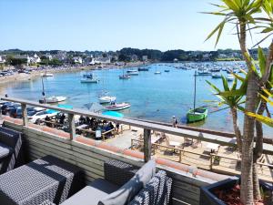a view of a marina with boats in the water at Hôtel des Rochers in Perros-Guirec