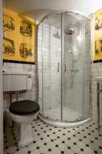 a bathroom with a toilet and a glass shower at Fagin's Den in Broadstairs - Winter special offers! in Broadstairs