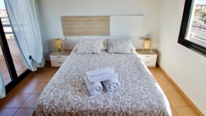 a bedroom with a bed with towels on it at The Wind's Breath, perfect for relaxing getaway in La Oliva +35 photos