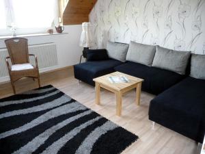 a living room with a couch and a coffee table at Ferienwohnung Schaefer in Heppenheim an der Bergstrasse