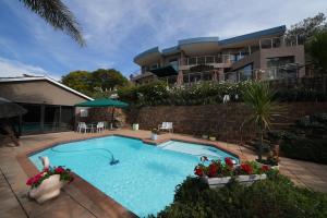 een zwembad voor een huis bij Over The Moon Guesthouse in Johannesburg