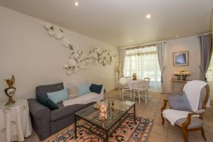 a living room with a couch and a table at Gite des Carmes and Spa in Le Thor