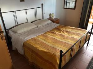 a bedroom with a bed with a metal frame at Villa Paradiso in Parenti