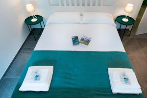 a bedroom with a bed with two towels on it at Villa Onedo in Abbadia Lariana
