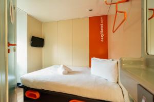 a small room with a bed and a tv at easyHotel Edinburgh in Edinburgh