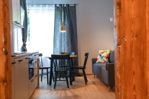 a kitchen and a living room with a table and chairs at Zagorski Apartment 2 in Kuressaare