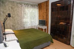 a small bedroom with a bed and a television at Zagorski Apartment 2 in Kuressaare