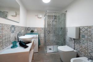 a bathroom with a sink and a toilet at Villa Onedo in Abbadia Lariana