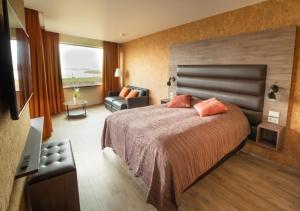 Postel nebo postele na pokoji v ubytování Hotel Kriunes