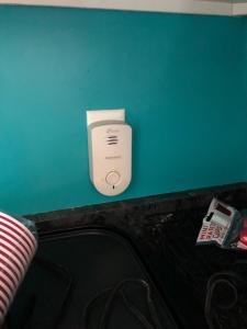 a white appliance sitting on a green wall at Newhouse Family Inn in Lewisville