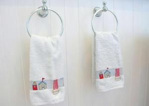 two towels with houses on them hanging on a wall at No12 Bed and Breakfast, St Andrews in St. Andrews