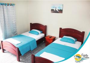 Tempat tidur dalam kamar di Hotel Galapagos Paradise