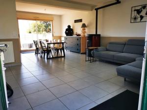 a living room with a couch and a table and chairs at VENT DE FOLIE in Le Crotoy